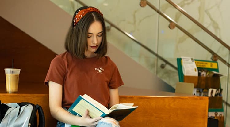 Student studying on bench